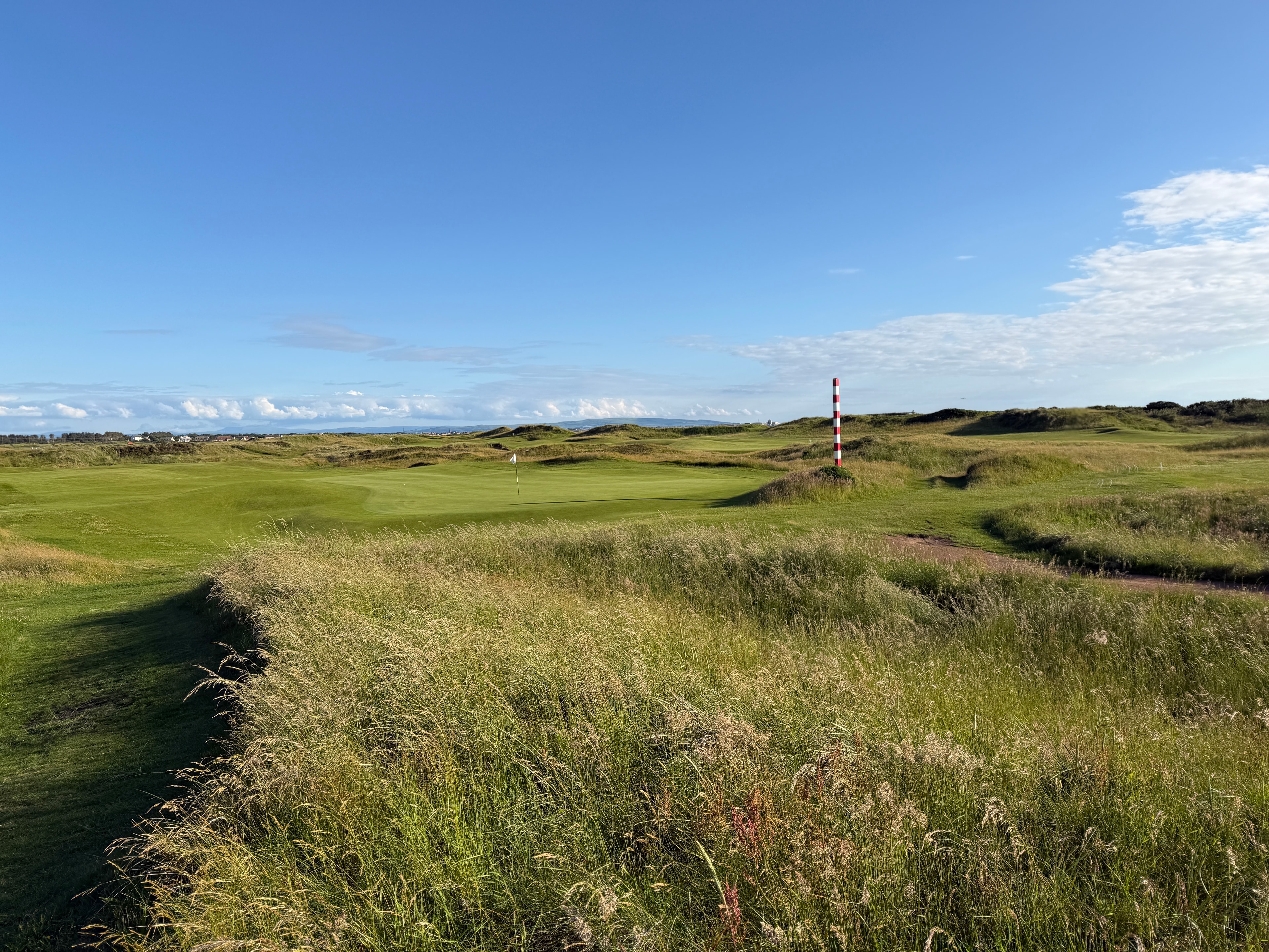 Classic Ayrshire links — the red-and-white post stands guard